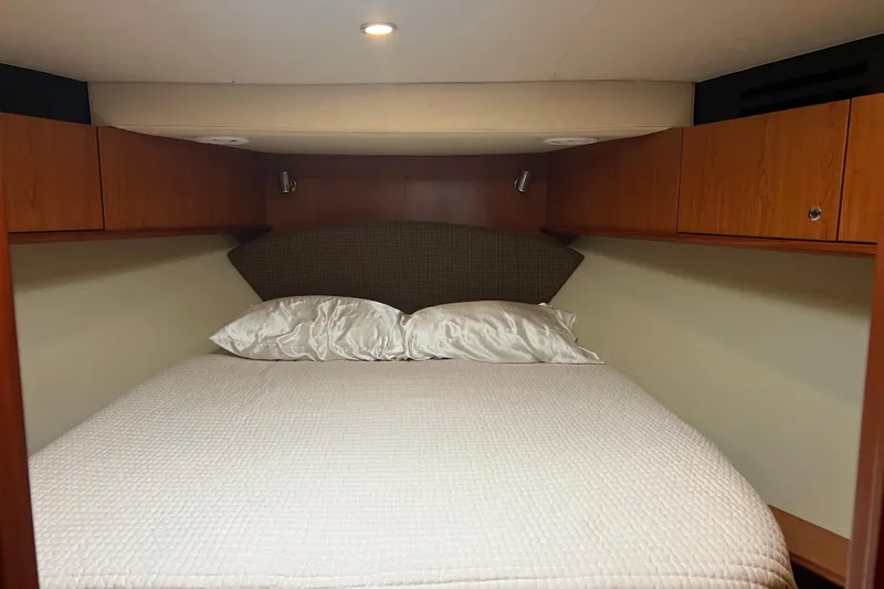  Yacht Photos Pics Luxurious cabin interior of 2008 Luhrs 35 Convertible yacht with cozy bed and wooden cabinets.