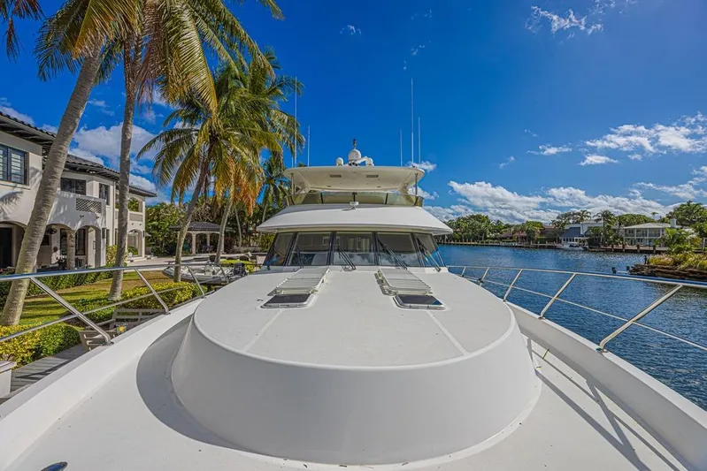 Margarita Yacht Photos Pics 2010 Ocean Alexander 74 Motoryacht docked by palm trees and waterfront homes.