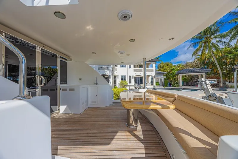 Margarita Yacht Photos Pics Luxurious 2010 Ocean Alexander 74 Motoryacht deck with seating and table, tropical backdrop.