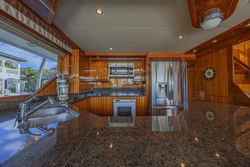 Margarita Yacht Photos Pics Luxurious kitchen interior of 2010 Ocean Alexander 74 Motoryacht with modern appliances and wood finish.