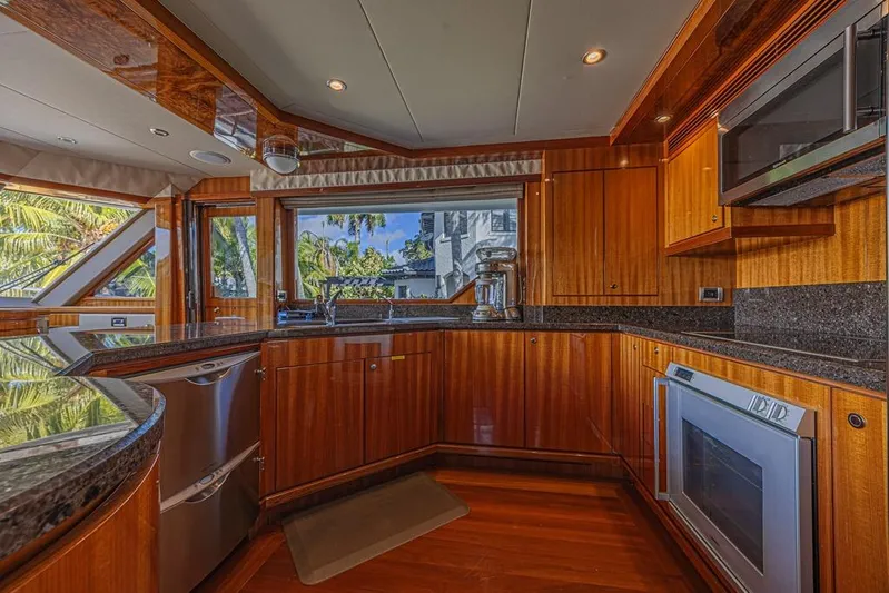 Margarita Yacht Photos Pics Luxurious kitchen interior of 2010 Ocean Alexander 74 Motoryacht with wood cabinetry and modern appliances.