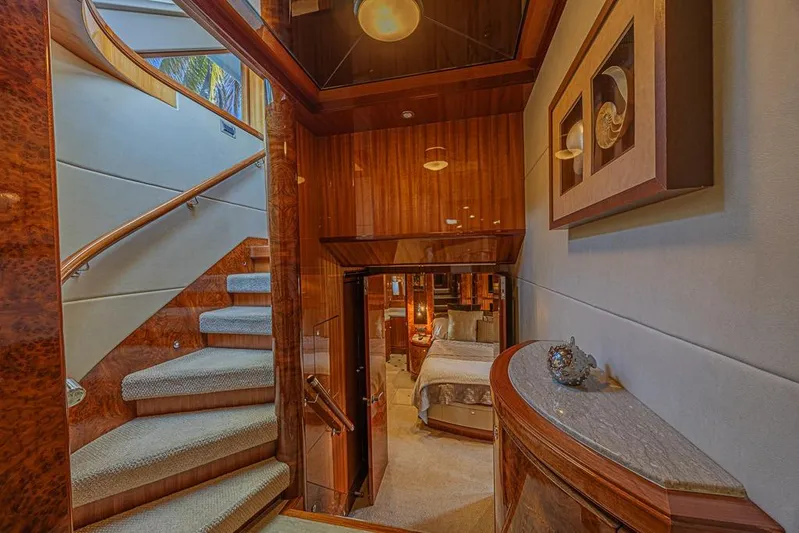 Margarita Yacht Photos Pics Luxurious interior of 2010 Ocean Alexander 74 Motoryacht with elegant staircase and bedroom.