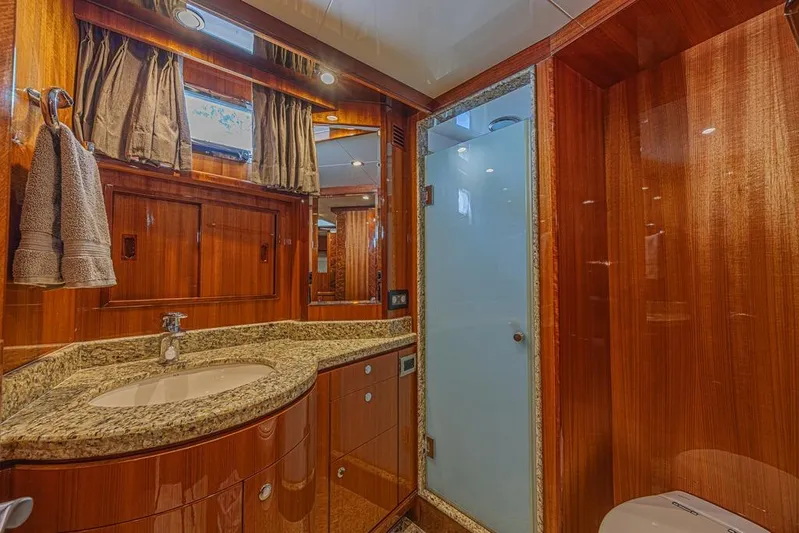 Margarita Yacht Photos Pics Luxurious bathroom in 2010 Ocean Alexander 74 Motoryacht with wood paneling and granite countertop.