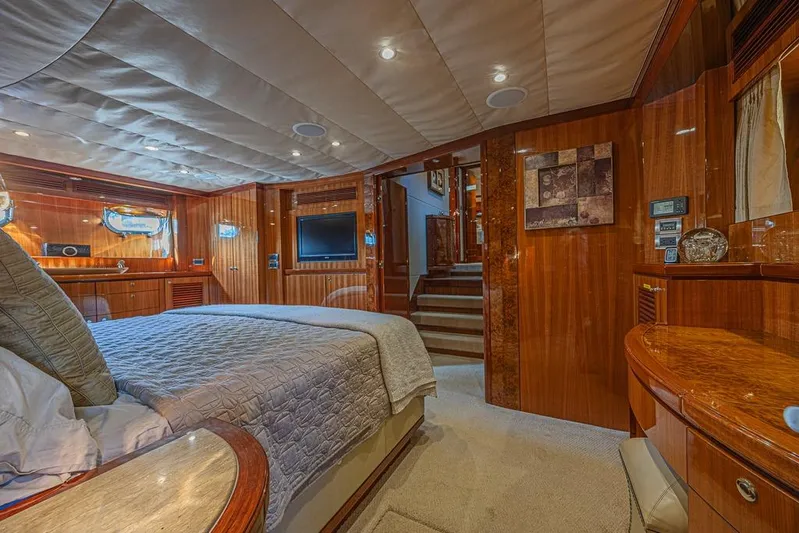 Margarita Yacht Photos Pics Luxurious bedroom interior of 2010 Ocean Alexander 74 Motoryacht with wood paneling and modern amenities.