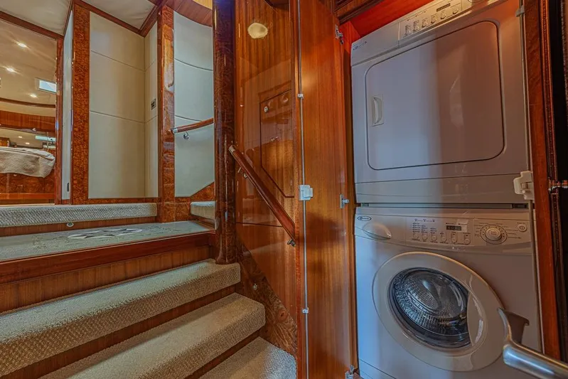 Margarita Yacht Photos Pics Laundry area inside 2010 Ocean Alexander 74 Motoryacht, featuring stacked washer and dryer.