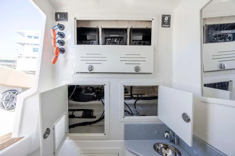  Yacht Photos Pics 2020 Blackwater 41 Tournament boat interior with open storage compartments and sink.