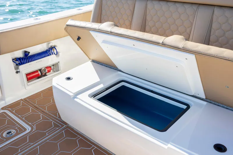  Yacht Photos Pics Open storage compartment on 2020 Blackwater 41 Tournament boat with tan seating and fire extinguisher.