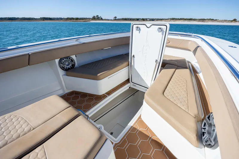  Yacht Photos Pics 2020 Blackwater 41 Tournament boat interior with tan seating and open storage compartment.