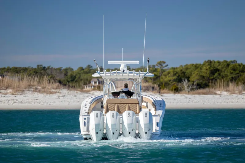  Yacht Photos Pics 2020 Blackwater 41 Tournament boat cruising near sandy shoreline.
