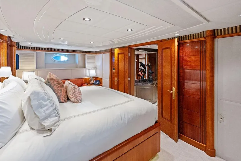 Picosa Lady Yacht Photos Pics Luxurious bedroom interior of 2001 West Bay 103 Sonship yacht with elegant wood finishes.