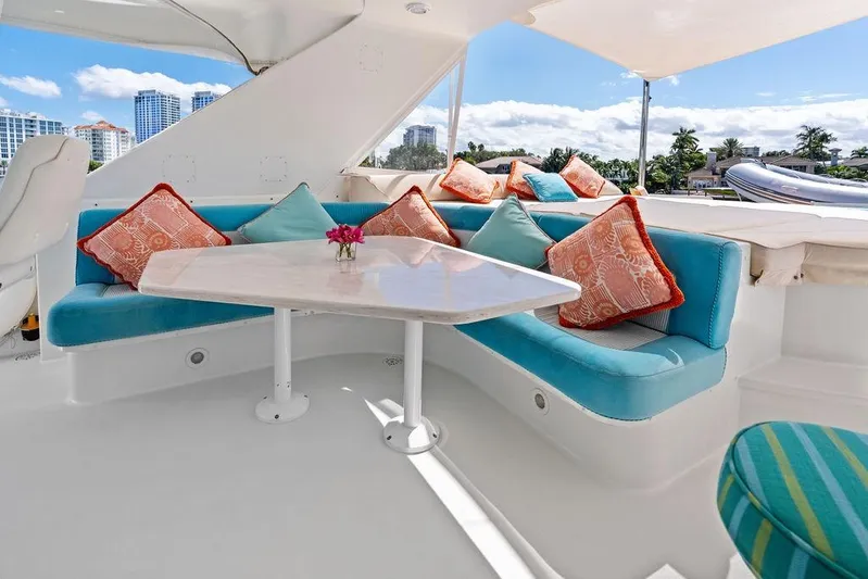Picosa Lady Yacht Photos Pics Luxurious seating area on 2001 West Bay 103 Sonship yacht with colorful cushions and table.