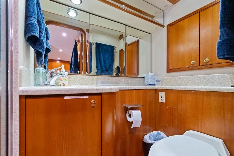 Picosa Lady Yacht Photos Pics Luxurious bathroom in 2001 West Bay 103 Sonship yacht with wooden cabinets and modern fixtures.