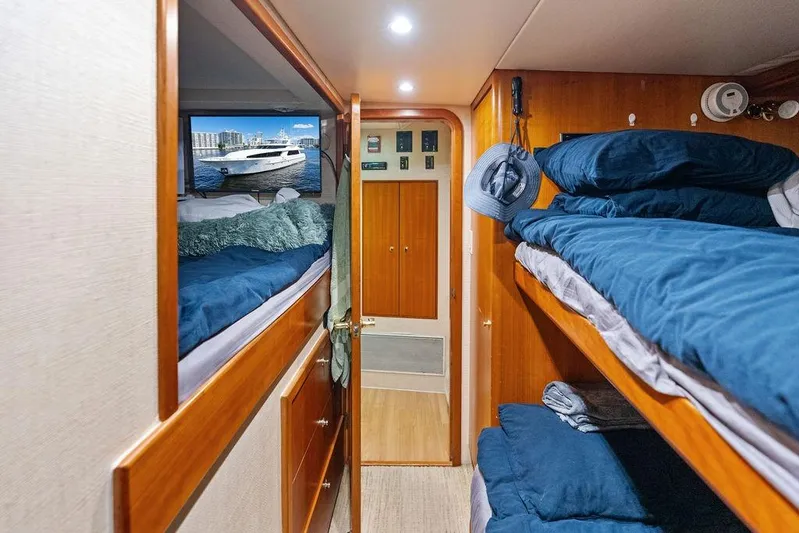 Picosa Lady Yacht Photos Pics Cozy cabin interior of 2001 West Bay 103 Sonship yacht with bunk beds and wooden finish.