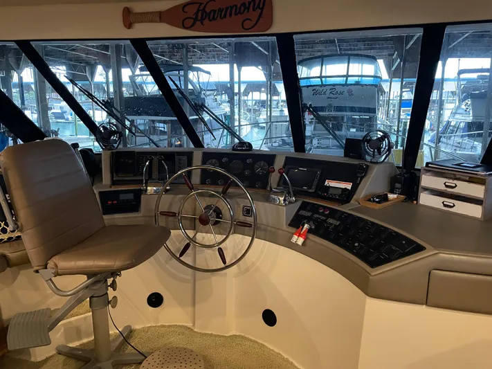 "harmony" Yacht Photos Pics 1995 Bayliner 4788 Pilot House Motoryacht helm with steering wheel and navigation controls.