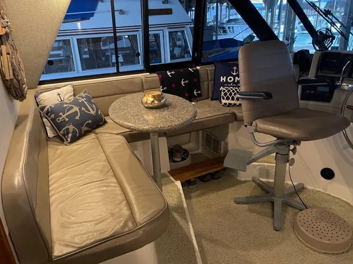 "harmony" Yacht Photos Pics Cozy interior of 1995 Bayliner 4788 Pilot House Motoryacht with seating and nautical decor.
