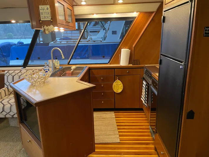 "harmony" Yacht Photos Pics 1995 Bayliner 4788 Pilot House Motoryacht kitchen with wood cabinetry and modern appliances.