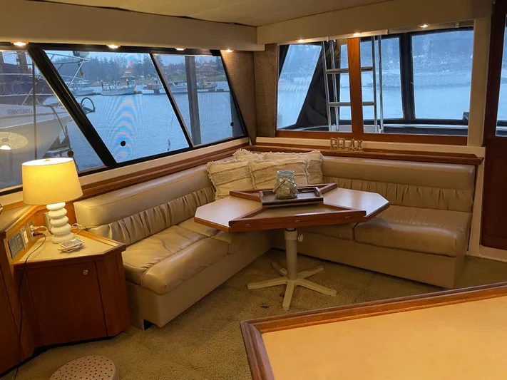 "harmony" Yacht Photos Pics Luxurious interior of a 1995 Bayliner 4788 Pilot House Motoryacht with cozy seating and elegant decor.