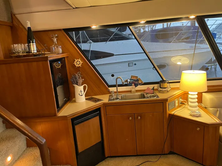 "harmony" Yacht Photos Pics Interior of 1995 Bayliner 4788 Pilot House Motoryacht with kitchenette and nautical decor.