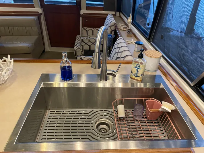 "harmony" Yacht Photos Pics Modern kitchen sink on 1995 Bayliner 4788 Pilot House Motoryacht with soap dispensers and drying rack.