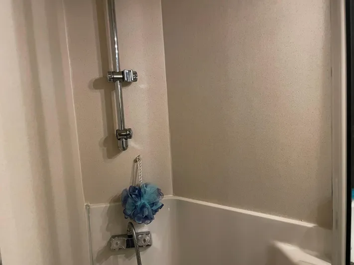 "harmony" Yacht Photos Pics Shower area in 1995 Bayliner 4788 Pilot House Motoryacht with blue bath sponge.