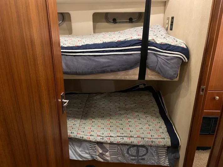 "harmony" Yacht Photos Pics Bunk beds in 1995 Bayliner 4788 Pilot House Motoryacht cabin, featuring cozy bedding.