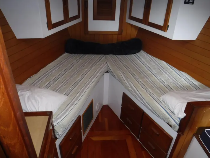" Loon Point " Yacht Photos Pics Cozy cabin interior of 1986 Custom 48 Trawler with twin beds and wooden accents.