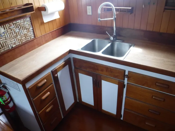 " Loon Point " Yacht Photos Pics Wooden kitchen interior with double sink on 1986 Custom 48 Trawler boat.