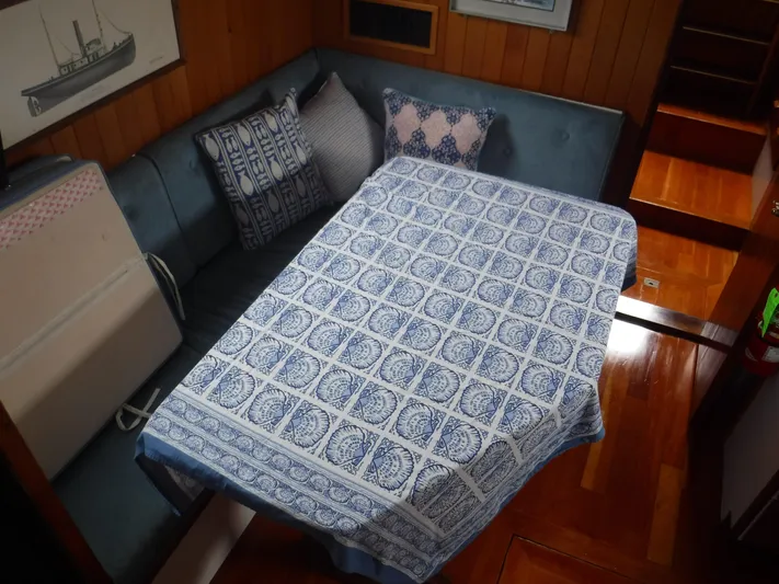 " Loon Point " Yacht Photos Pics Cozy interior of 1986 Custom 48 Trawler with patterned tablecloth and cushions.