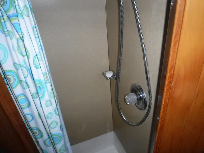 " Loon Point " Yacht Photos Pics Shower area in 1986 Custom 48 Trawler with patterned curtain and chrome fixtures.