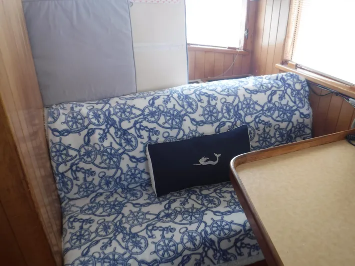 " Loon Point " Yacht Photos Pics Cozy seating area on 1986 Custom 48 Trawler with nautical-themed upholstery.
