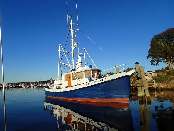 " Loon Point " Yacht Photos Pics 1986 Custom 48 Trawler docked in a serene marina under a clear blue sky.