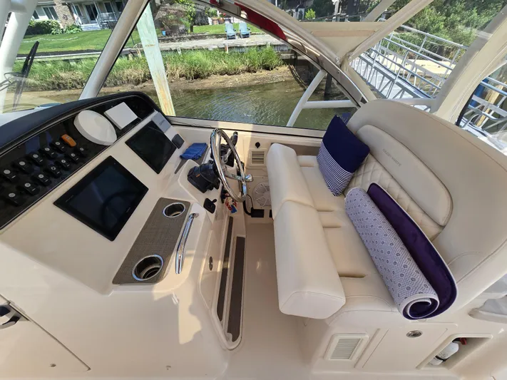  Yacht Photos Pics 2017 Grady-White Freedom 335 boat interior with helm, steering wheel, and cushioned seating.