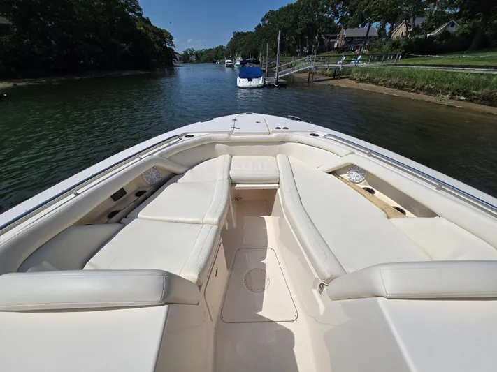  Yacht Photos Pics 2017 Grady-White Freedom 335 boat interior with spacious seating on a calm waterway.