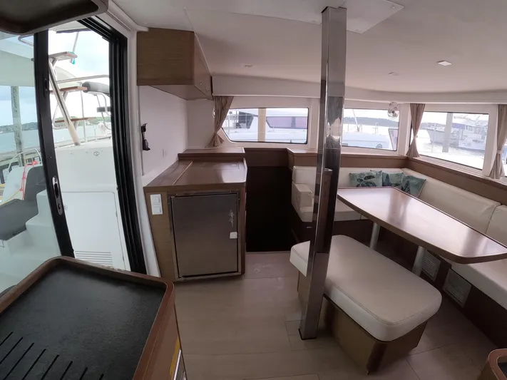 Oceanfront Yacht Photos Pics Interior of 2019 Lagoon 42 catamaran with modern seating and dining area.