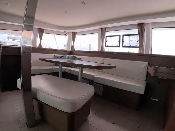 Oceanfront Yacht Photos Pics Interior of 2019 Lagoon 42 catamaran with spacious seating and large windows.