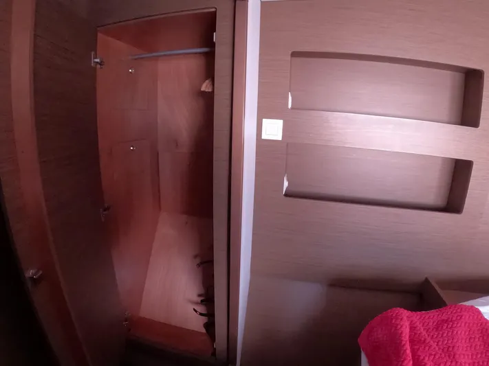 Oceanfront Yacht Photos Pics Interior of 2019 Lagoon 42 yacht showing wooden closet and wall shelves.