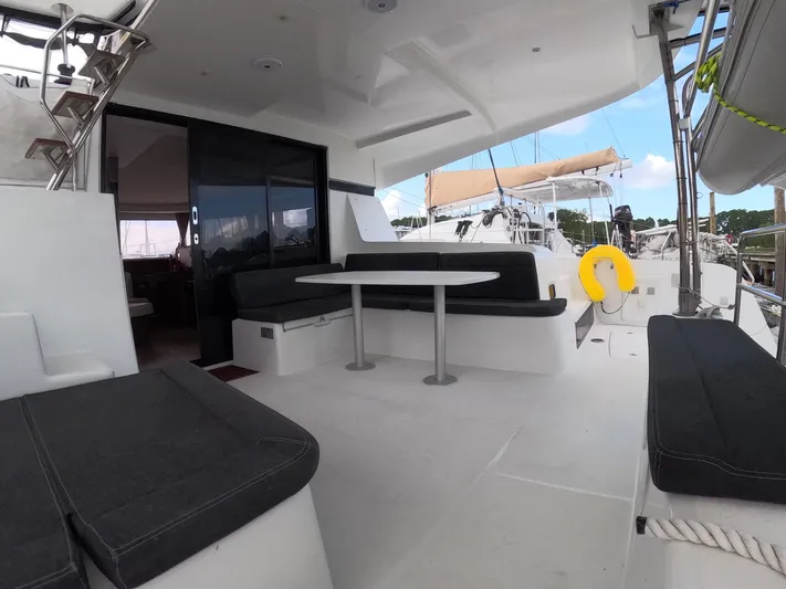 Oceanfront Yacht Photos Pics Spacious deck of 2019 Lagoon 42 catamaran with seating and table.