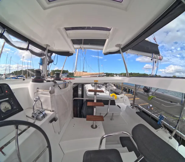 Oceanfront Yacht Photos Pics Interior view of a 2019 Lagoon 42 catamaran, showcasing helm and seating area.