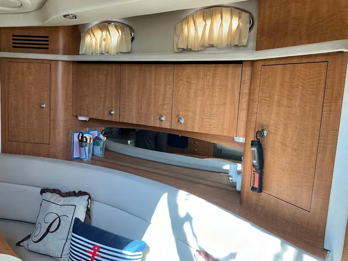 Sapphire N Rhythm Yacht Photos Pics Interior of 2006 Sea Ray 340 Sundancer with wooden cabinets and cozy seating area.