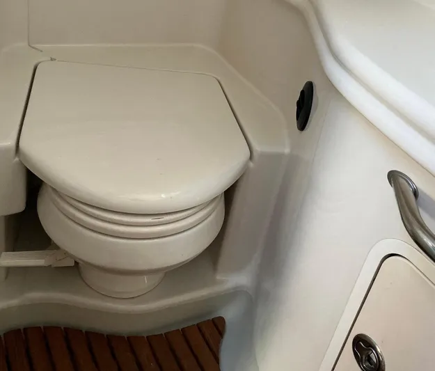 Sapphire N Rhythm Yacht Photos Pics 2006 Sea Ray 340 Sundancer boat bathroom with compact toilet and wooden flooring.