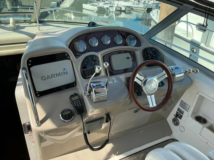 Sapphire N Rhythm Yacht Photos Pics 2006 Sea Ray 340 Sundancer helm with Garmin navigation, steering wheel, and control panel.