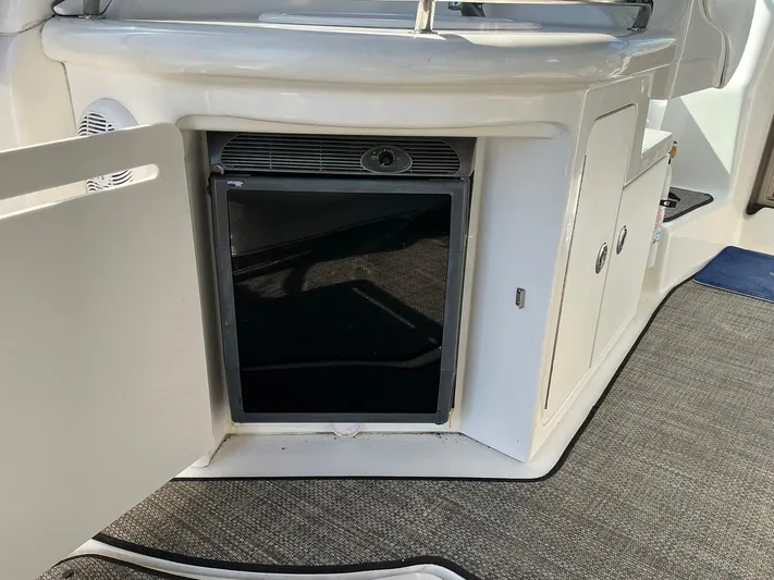 Sapphire N Rhythm Yacht Photos Pics 2006 Sea Ray 340 Sundancer interior with open cabinet and mini fridge.