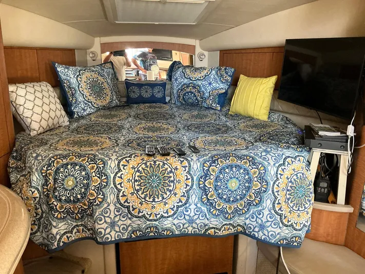 Sapphire N Rhythm Yacht Photos Pics Luxurious cabin interior of 2006 Sea Ray 340 Sundancer with patterned bedding and TV.