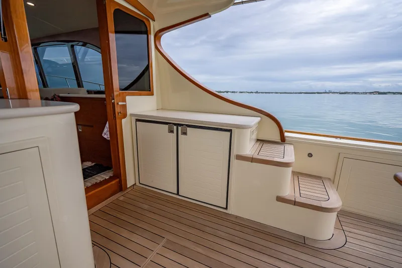 Date Night Yacht Photos Pics Luxurious 2020 Palm Beach Motor Yachts PB50 interior with elegant wood finish and ocean view.