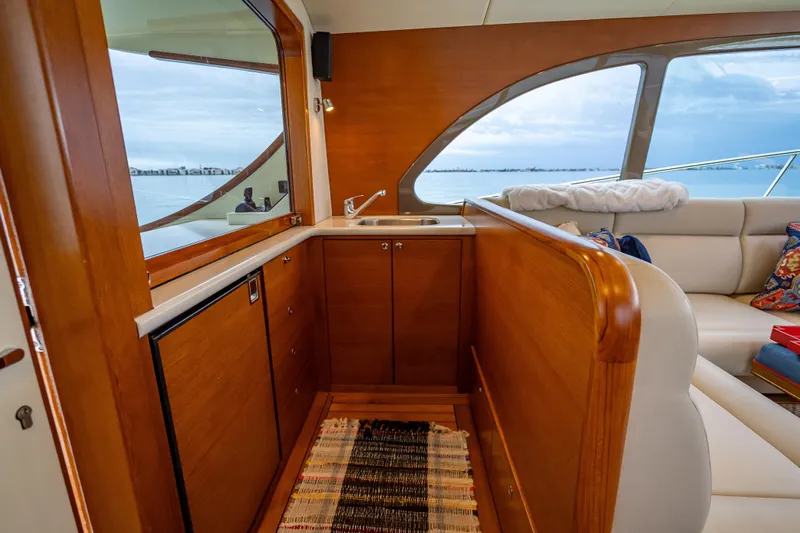 Date Night Yacht Photos Pics Luxurious interior of 2020 Palm Beach Motor Yachts PB50 with wood finish and ocean view.