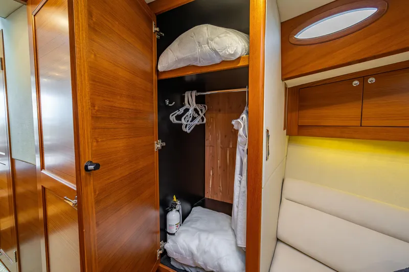 Date Night Yacht Photos Pics 2020 Palm Beach Motor Yachts PB50 interior closet with wooden finish and storage space.