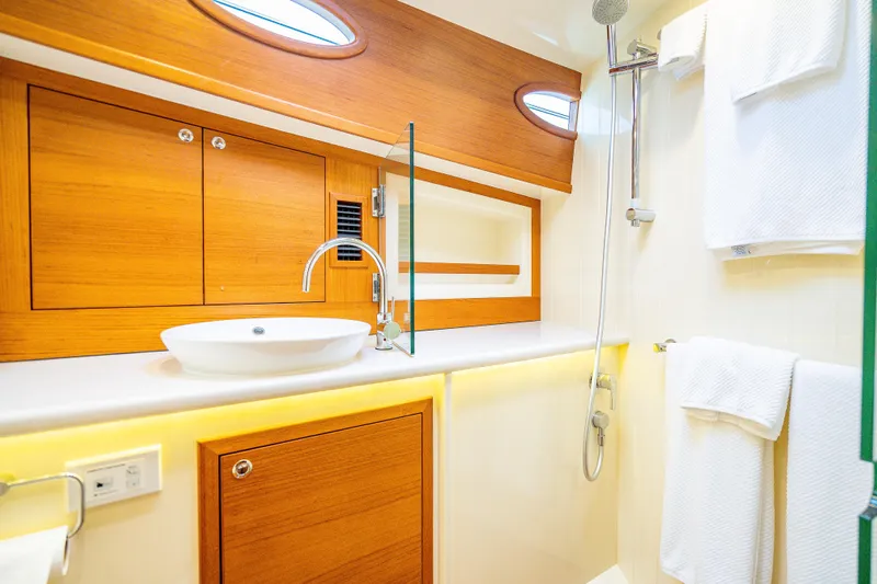 Date Night Yacht Photos Pics Luxurious bathroom in 2020 Palm Beach Motor Yachts PB50, featuring elegant wood cabinetry and modern fixtures.
