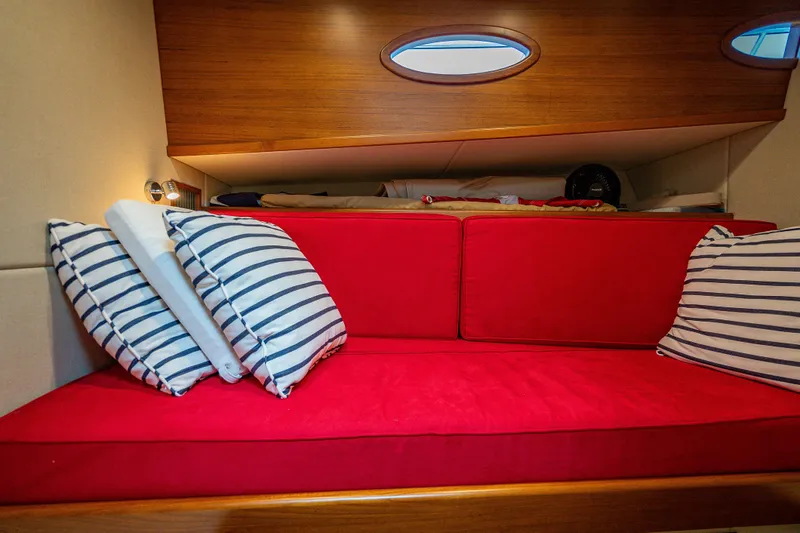 Date Night Yacht Photos Pics 2020 Palm Beach Motor Yachts PB50 interior with red seating and striped pillows.