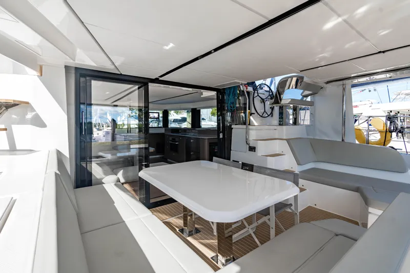 C1022 Yacht Photos Pics Luxurious interior of 2025 Leopard 46 yacht with modern seating and dining area.