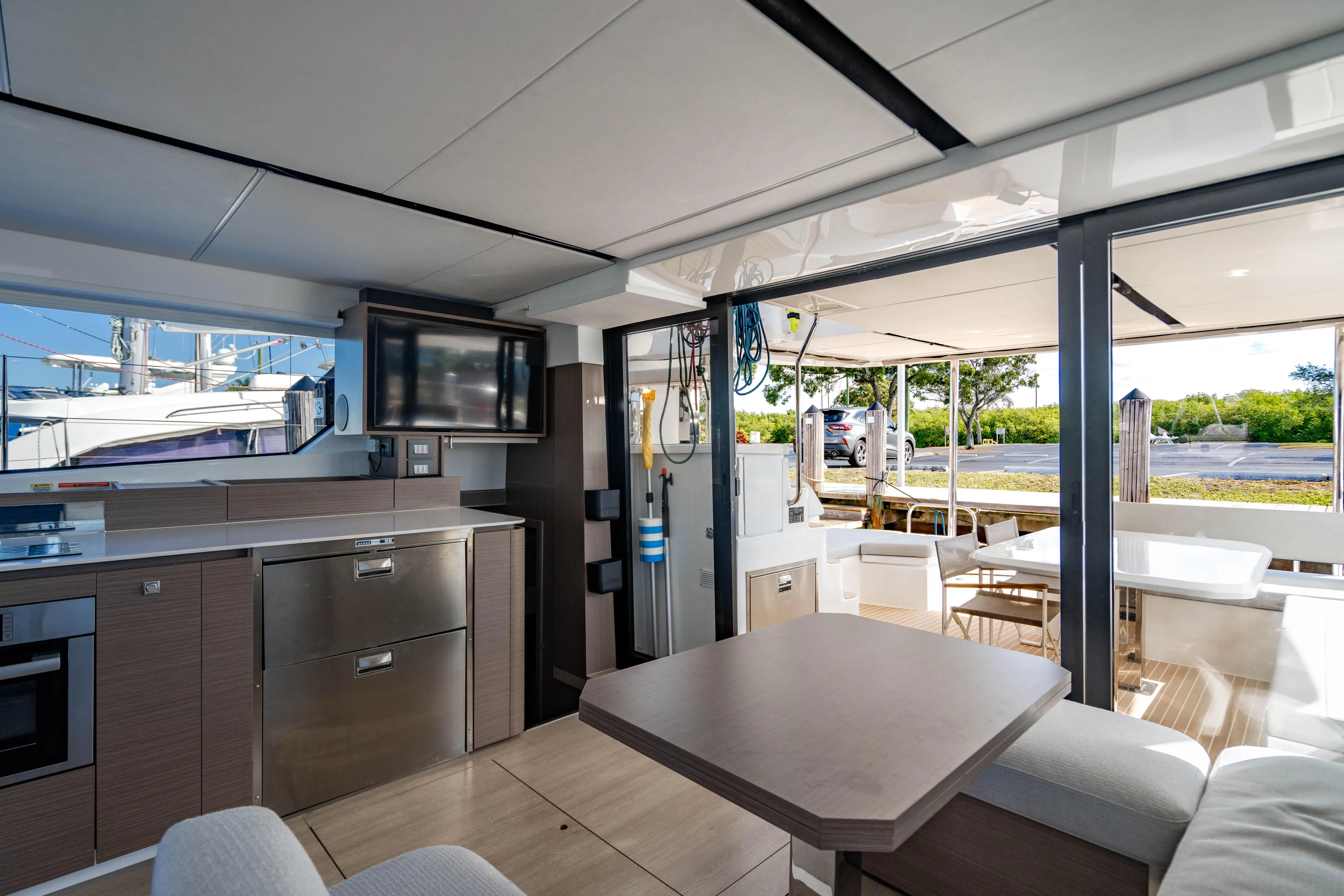 C1022 Yacht Photos Pics Luxurious interior of 2025 Leopard 46 yacht with modern kitchen and outdoor seating.